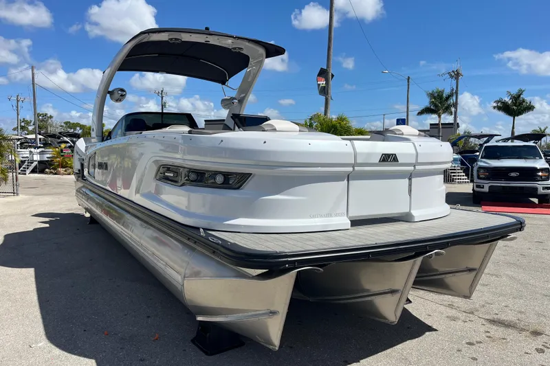 Slide: The Image of 2026 Avalon 2785 Excalibur Carbon Series Tri Toon with Twin Mercury Racing 500R's, docked. - 2