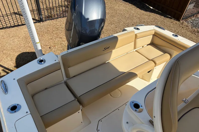 Slide: The Image of 2017 Scout 225 XSF boat with beige seating and outboard motor. - 10