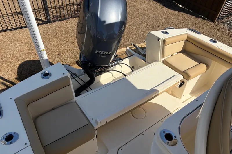 Slide: The Image of 2017 Scout 225 XSF boat interior with Yamaha 200 engine, beige seating, and cup holders. - 11