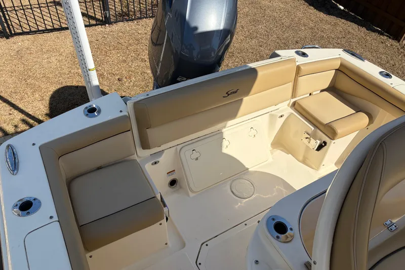 Slide: The Image of 2017 Scout 225 XSF boat interior with beige seating and cup holders. - 12