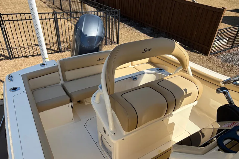 Slide: The Image of 2017 Scout 225 XSF boat interior with beige seating and steering console. - 14
