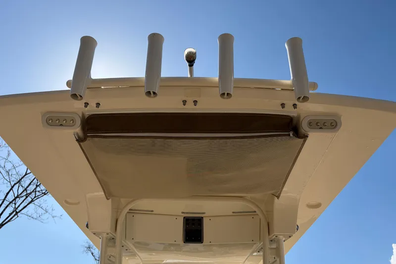 Slide: The Image of 2017 Scout 225 XSF boat top view with rod holders against clear blue sky. - 25