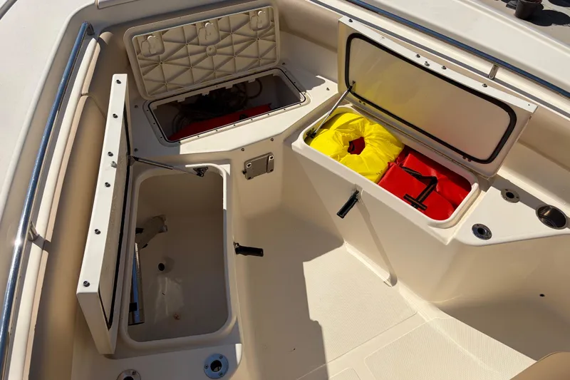 Slide: The Image of 2017 Scout 225 XSF boat storage compartments with safety gear and equipment. - 26