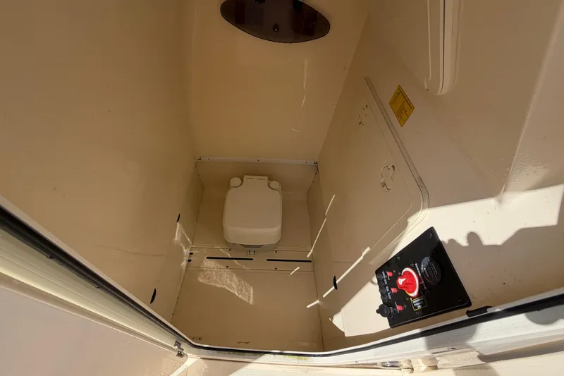Slide: The Image of 2017 Scout 225 XSF boat interior with portable toilet and control panel. - 27