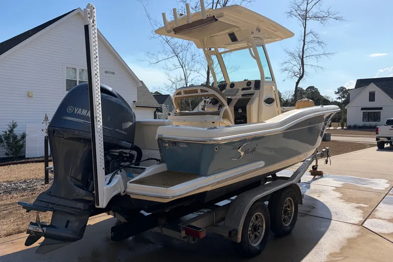 Slide: The Image of 2017 Scout 225 XSF boat on trailer with Yamaha engine in residential driveway. - 3