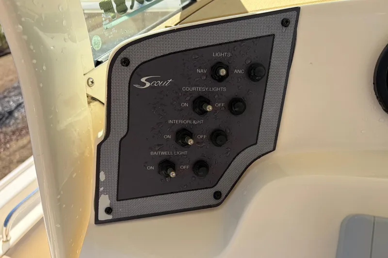 Slide: The Image of Control panel of a 2017 Scout 225 XSF boat with various light switches. - 30