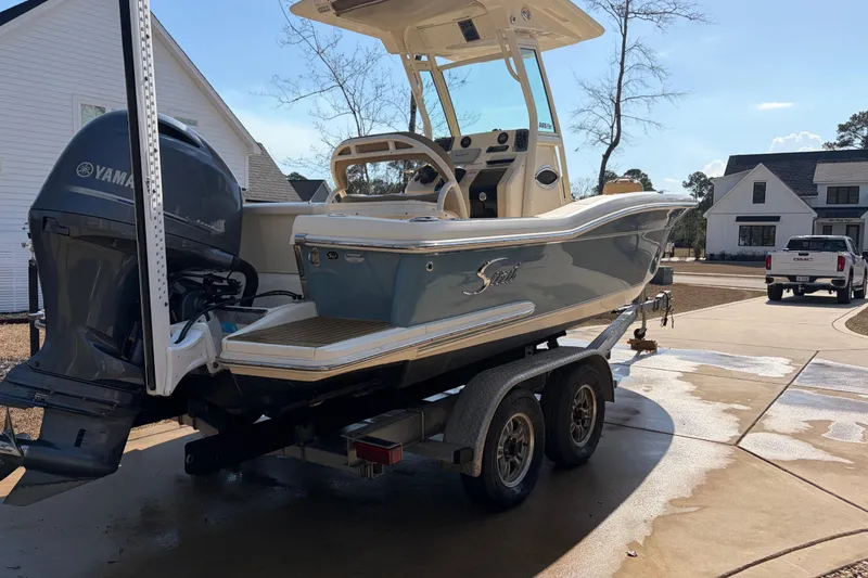 Slide: The Image of 2017 Scout 225 XSF boat on trailer with Yamaha engine in residential driveway. - 4