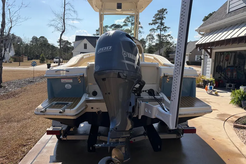 Slide: The Image of 2017 Scout 225 XSF boat with Yamaha 200 engine on trailer in driveway. - 5