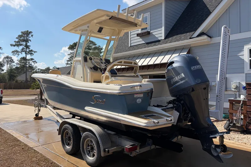 Slide: The Image of 2017 Scout 225 XSF boat with Yamaha engine on trailer, parked in driveway. - 6