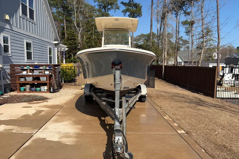 Slide: The Image of 2017 Scout 225 XSF boat on trailer in residential driveway. - 9