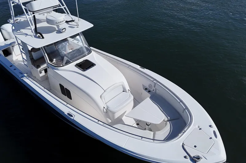 Slide: The Image of 2017 Edgewater 368CC boat on water, showcasing sleek design and spacious deck. - 16