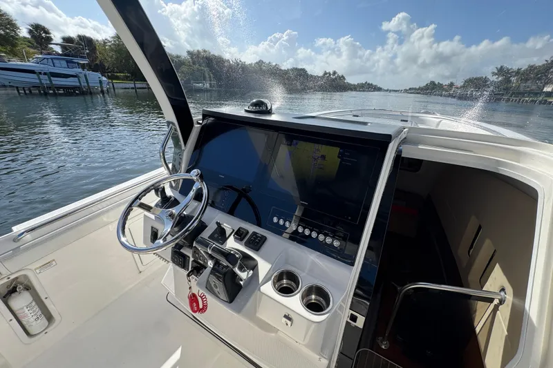 Slide: The Image of Edgewater 368CC 2017 boat helm with steering wheel and navigation display. - 18