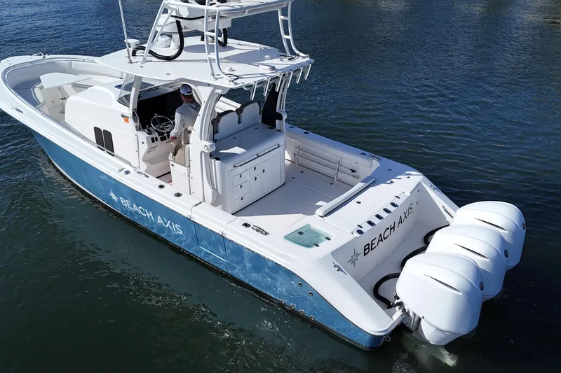 Slide: The Image of 2017 Edgewater 368CC boat with triple engines on water, labeled "BEACH AXIS." - 21