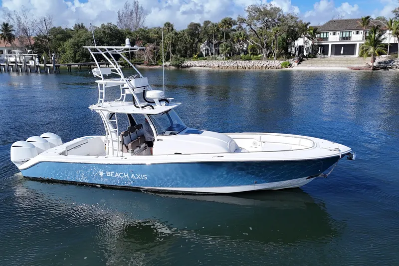 Slide: The Image of 2017 Edgewater 368CC boat on calm water, featuring a sleek blue and white design. - 3