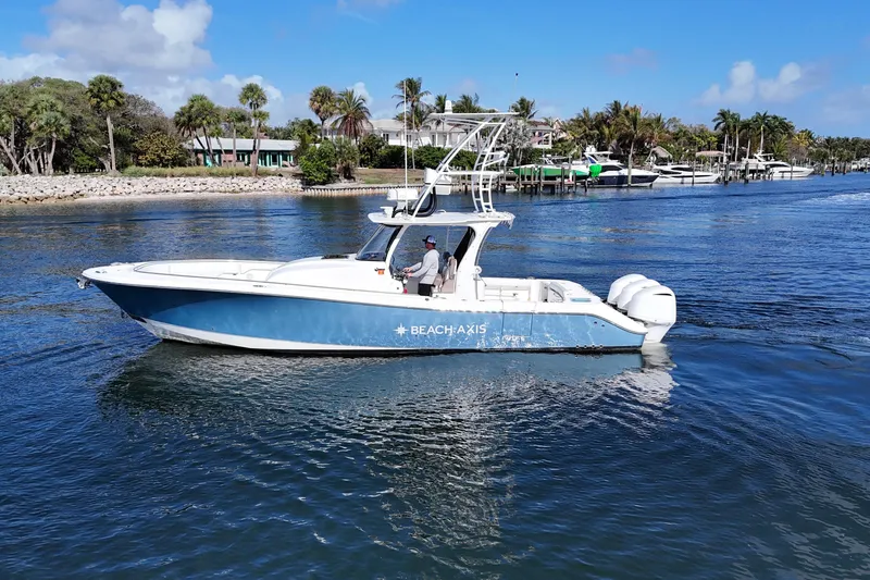 Slide: The Image of 2017 Edgewater 368CC boat cruising on a scenic waterway. - 8