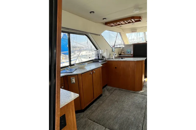 Slide: The Image of Interior of 1996 Bayliner 3788 Command Bridge Motoryacht with modern kitchen and large windows. - 11