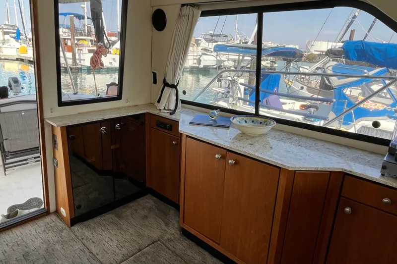 Slide: The Image of Interior of 1996 Bayliner 3788 Command Bridge Motoryacht with marina view through windows. - 12