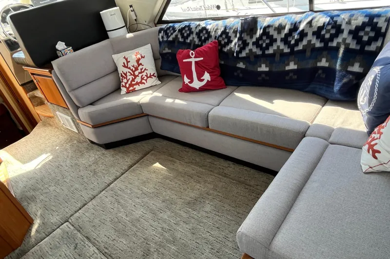 Slide: The Image of Interior of 1996 Bayliner 3788 yacht with cozy seating and nautical-themed decor. - 14