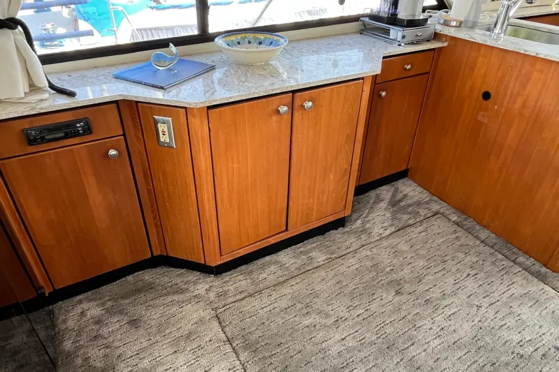 Slide: The Image of 1996 Bayliner 3788 Command Bridge Motoryacht interior with wooden cabinets and marble countertop. - 15