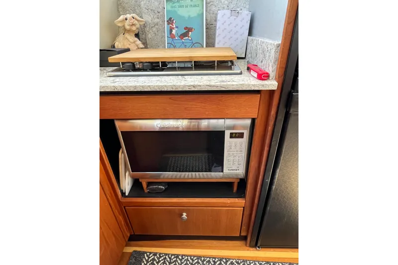 Slide: The Image of 1996 Bayliner 3788 Command Bridge Motoryacht kitchen with microwave and stove. - 21