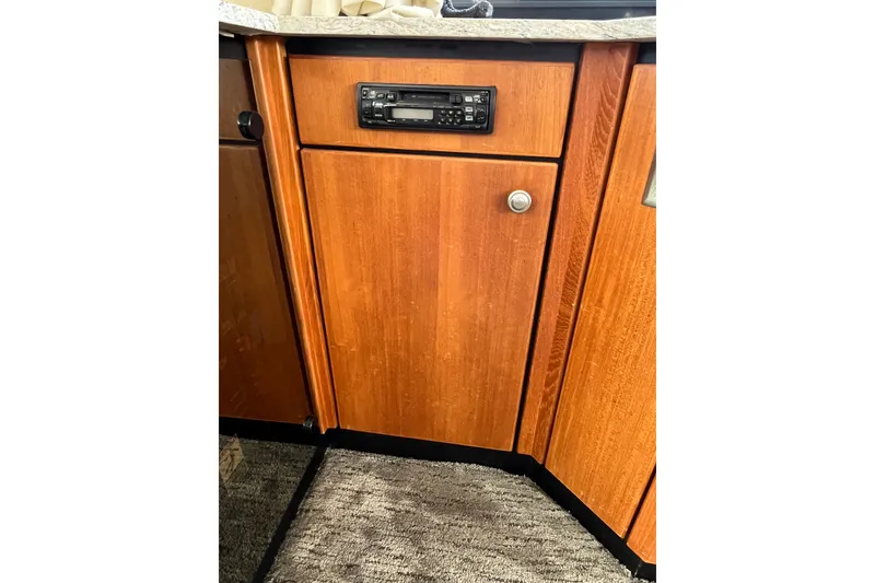 Slide: The Image of 1996 Bayliner 3788 Command Bridge Motoryacht interior wood cabinetry with built-in stereo system. - 24