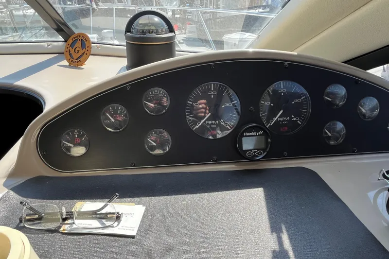 Slide: The Image of 1996 Bayliner 3788 Command Bridge Motoryacht dashboard with gauges and compass. - 25