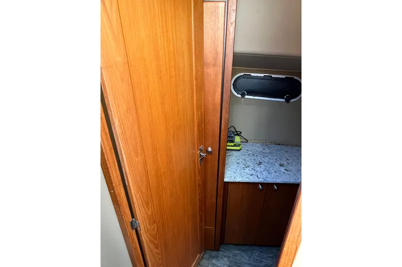 Slide: The Image of 1996 Bayliner 3788 Command Bridge Motoryacht interior with wooden cabinetry and countertop. - 29