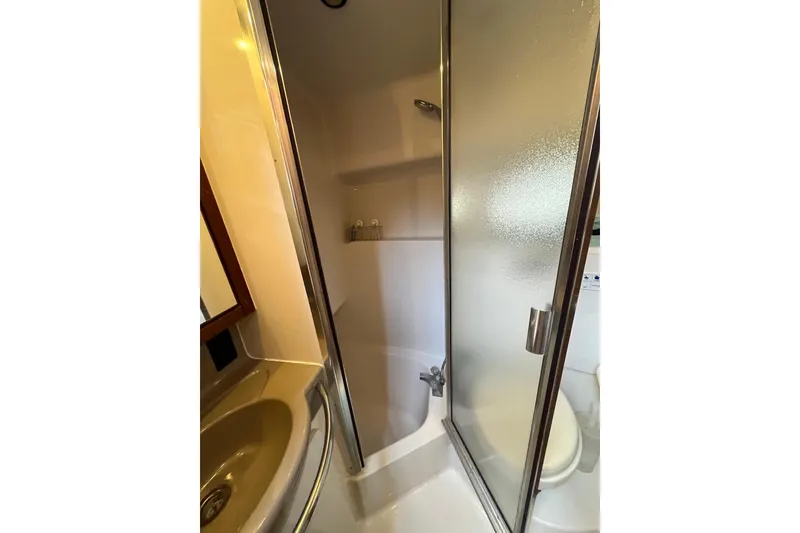 Slide: The Image of 1996 Bayliner 3788 Command Bridge Motoryacht bathroom with shower and sink. - 31