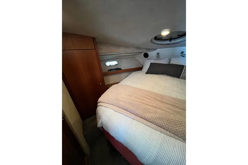 Slide: The Image of Cozy bedroom in 1996 Bayliner 3788 Command Bridge Motoryacht with wood accents and porthole. - 32