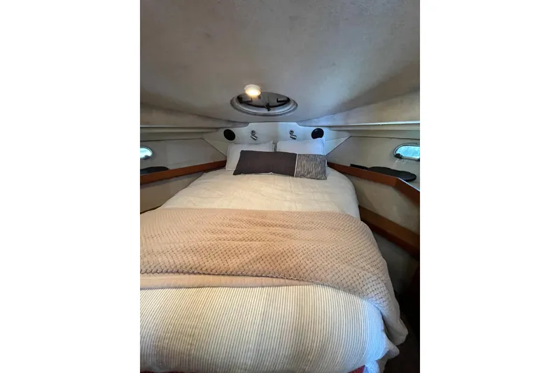 Slide: The Image of Cozy bedroom interior of 1996 Bayliner 3788 Command Bridge Motoryacht with plush bedding. - 33