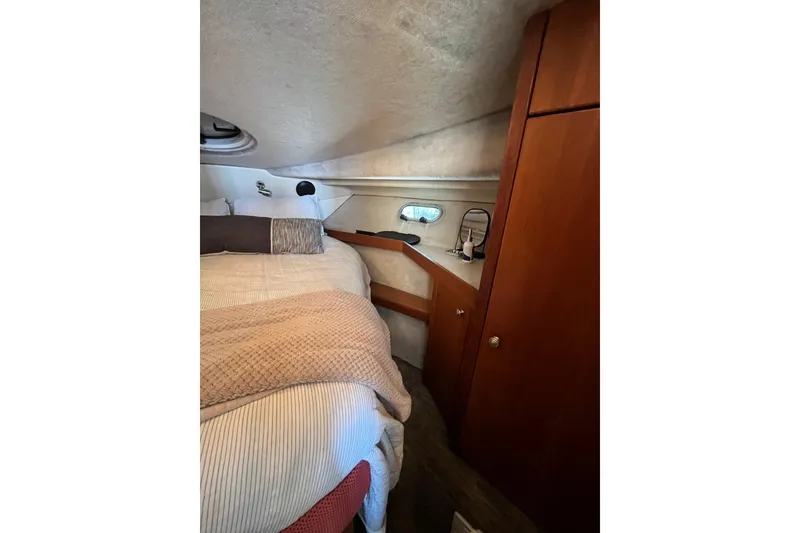 Slide: The Image of Cozy cabin interior of 1996 Bayliner 3788 Command Bridge Motoryacht with bed and wooden cabinetry. - 34