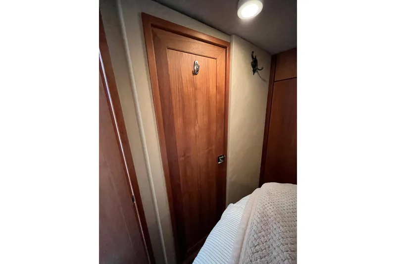 Slide: The Image of Wooden cabin door inside 1996 Bayliner 3788 Command Bridge Motoryacht, featuring cozy interior lighting. - 35