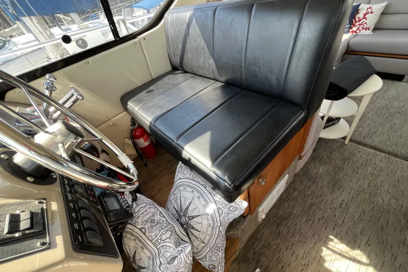 Slide: The Image of Interior of 1996 Bayliner 3788 Command Bridge Motoryacht with black seating and steering wheel. - 37