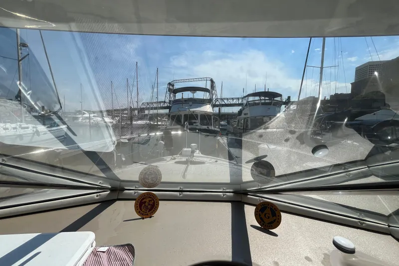 Slide: The Image of View from 1996 Bayliner 3788 Command Bridge Motoryacht, docked in a marina under clear skies. - 38
