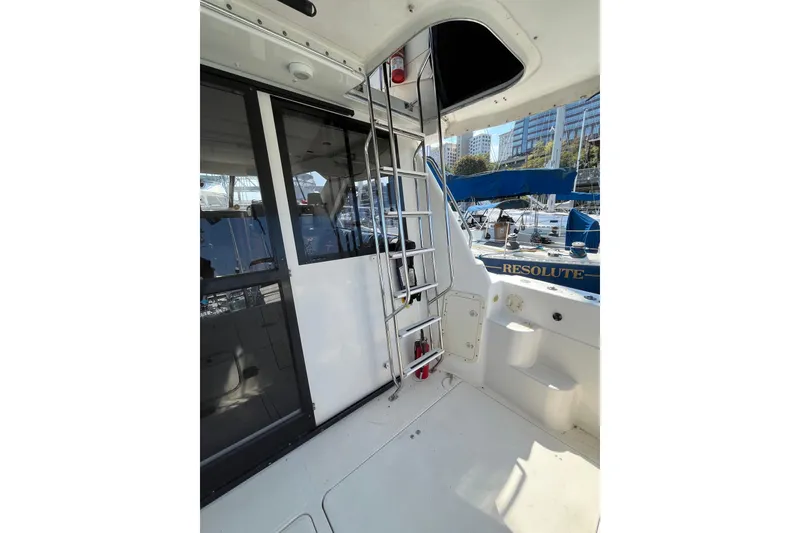Slide: The Image of 1996 Bayliner 3788 Command Bridge Motoryacht interior with ladder and marina view. - 4