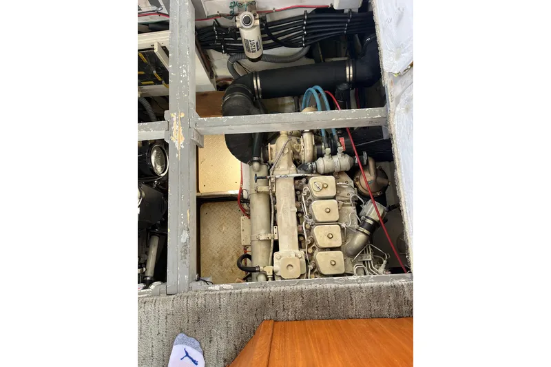 Slide: The Image of Engine compartment of a 1996 Bayliner 3788 Command Bridge Motoryacht, showcasing mechanical components. - 43