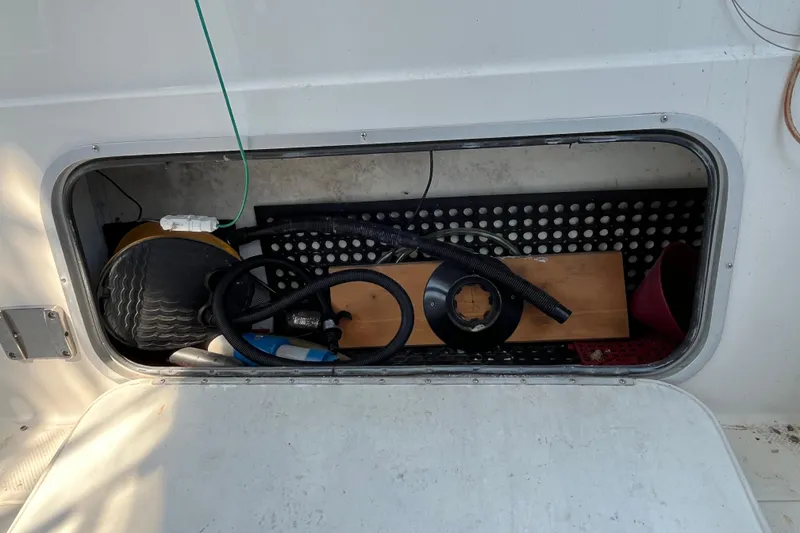 Slide: The Image of Storage compartment on a 1996 Bayliner 3788 Command Bridge Motoryacht with various equipment. - 8