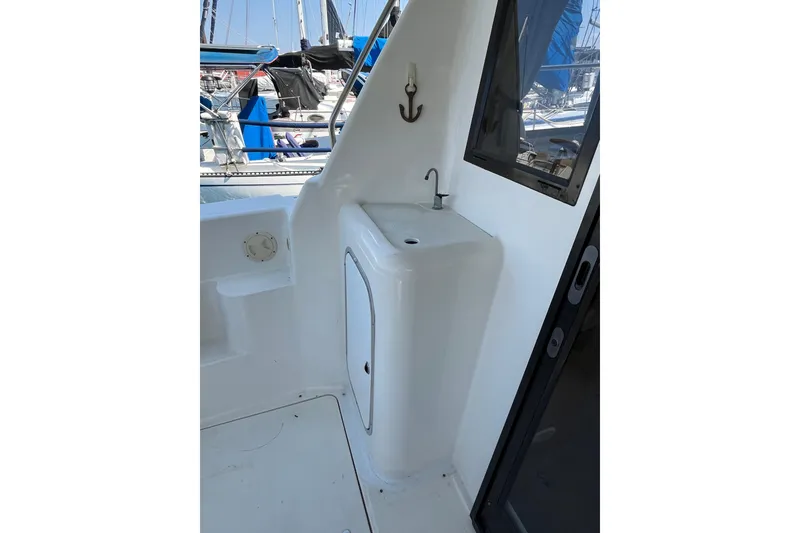 Slide: The Image of 1996 Bayliner 3788 Command Bridge Motoryacht sink area with window and anchor hook. - 9