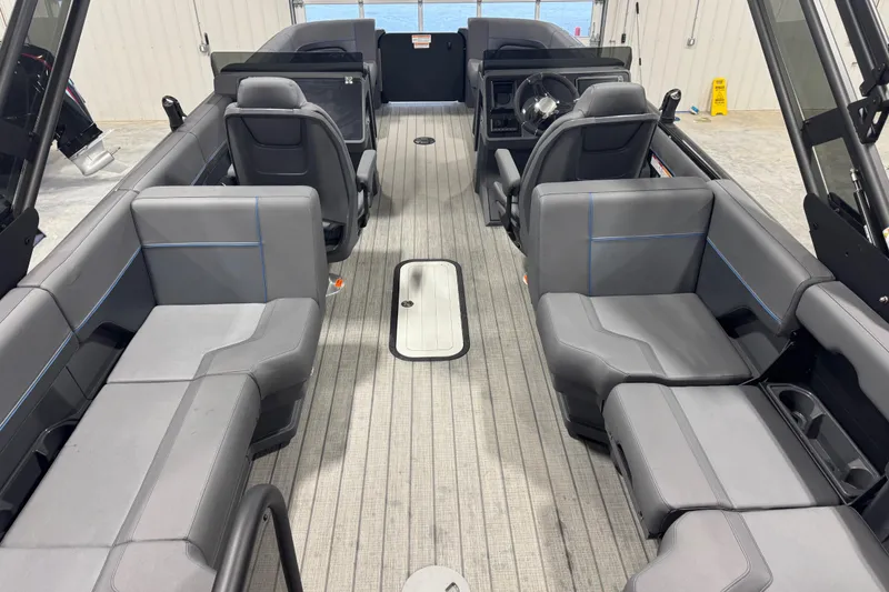 Slide: The Image of 2025 Manitou 24 Explore boat interior with gray seating and modern design. - 10
