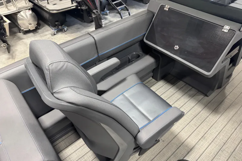 Slide: The Image of 2025 Manitou 24 Explore boat interior with sleek gray seating and modern design. - 12
