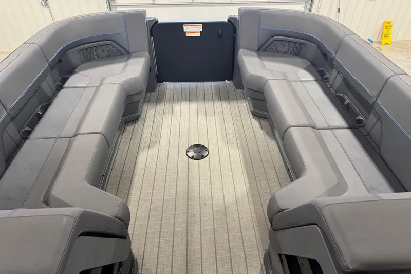 Slide: The Image of 2025 Manitou 24 Explore boat interior with spacious seating and modern design. - 13