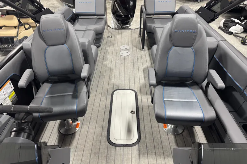 Slide: The Image of 2025 Manitou 24 Explore boat interior with gray seating and modern design. - 14