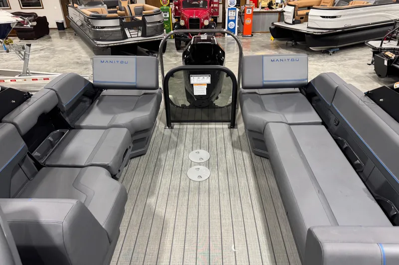 Slide: The Image of 2025 Manitou 24 Explorer pontoon boat interior with gray seating and modern design. - 10