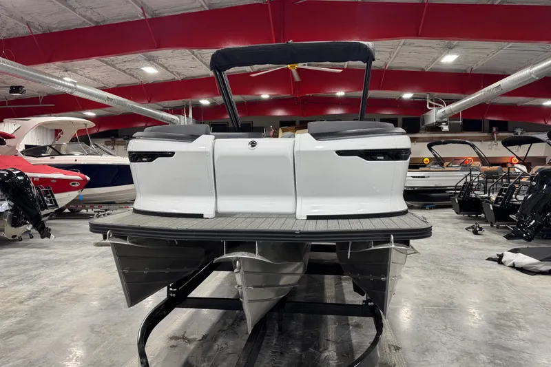 Slide: The Image of 2025 Manitou 24 Explorer pontoon boat in showroom, rear view. - 7
