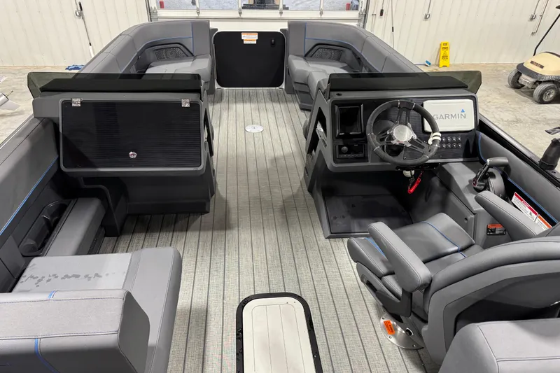 Slide: The Image of 2025 Manitou 24 Explorer boat interior with modern seating and Garmin navigation system. - 8