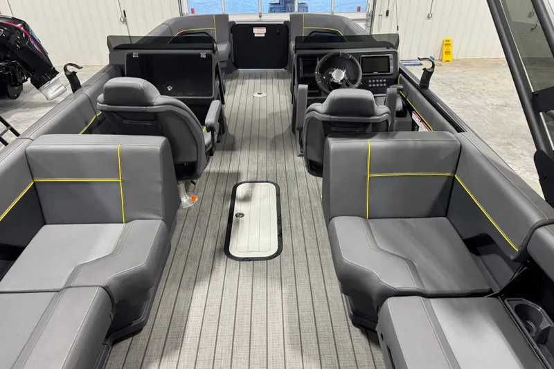 Slide: The Image of 2024 Manitou 24 Explorer interior with modern seating and steering console. - 10