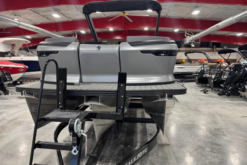 Slide: The Image of 2024 Manitou 24 Explorer pontoon boat in showroom, rear view with ladder. - 5