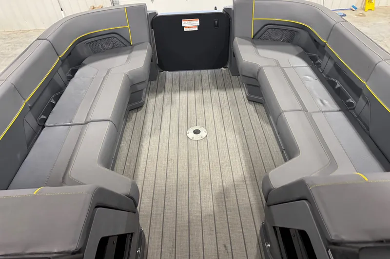 Slide: The Image of 2024 Manitou 24 Explorer interior with gray seating and yellow accents. - 7