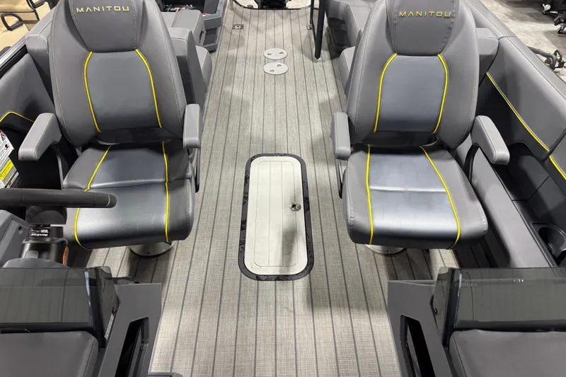 Slide: The Image of 2024 Manitou 24 Explorer interior with gray seats and yellow accents. - 9