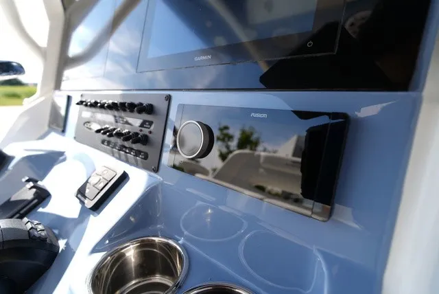 Slide: The Image of Close-up of the helm of a Cobia 245 Center Console boat with modern instruments. - 25
